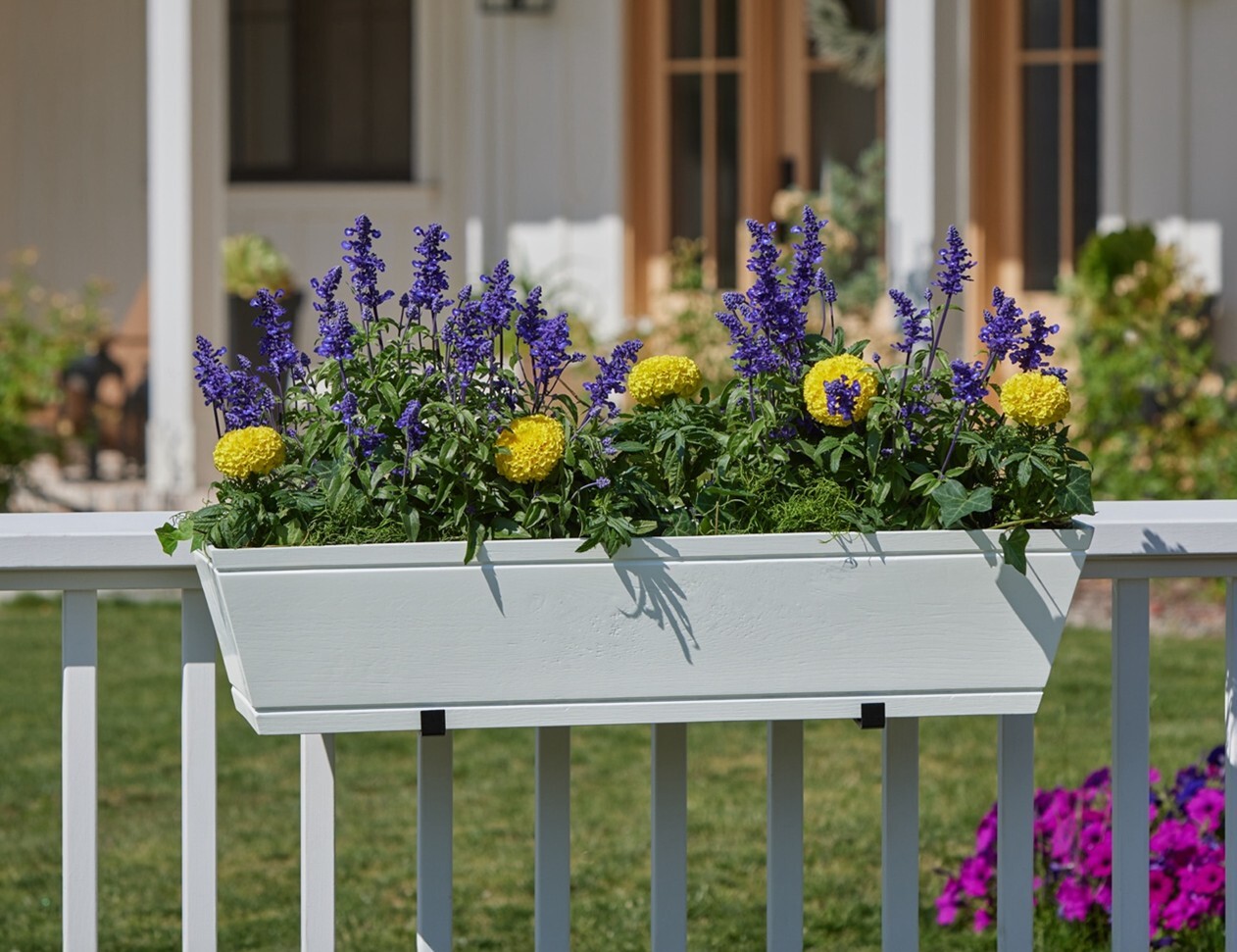 White Modern Farmhouse Railing Planter on white wood fence with home in background