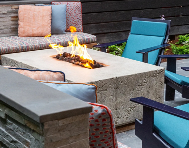 Coral Fire Table with flames in center of seating area